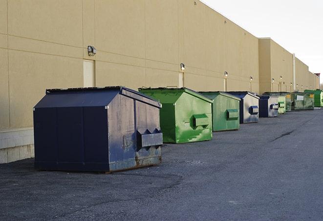 construction crew disposing of building materials in large bins in Eaton, CO